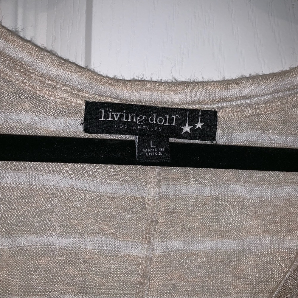 Tan colored stripe top with lace at bottom.